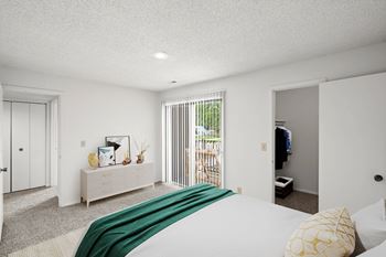 Bedroom with a large and comfortable bed  and closet at Bremerton Park Apartment Homes , Prairie Village, KS, 66204